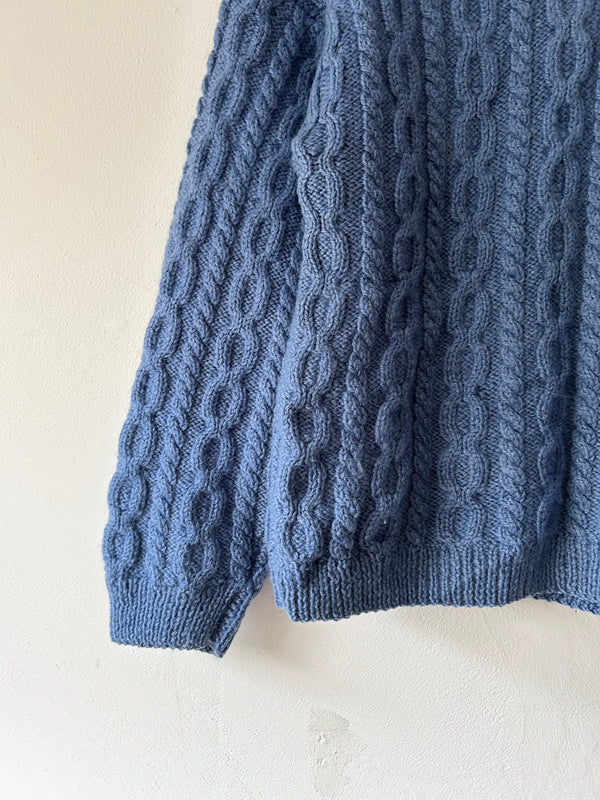 Blue hand cable knit.