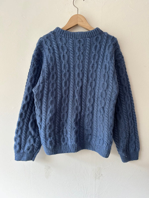 Blue hand cable knit.