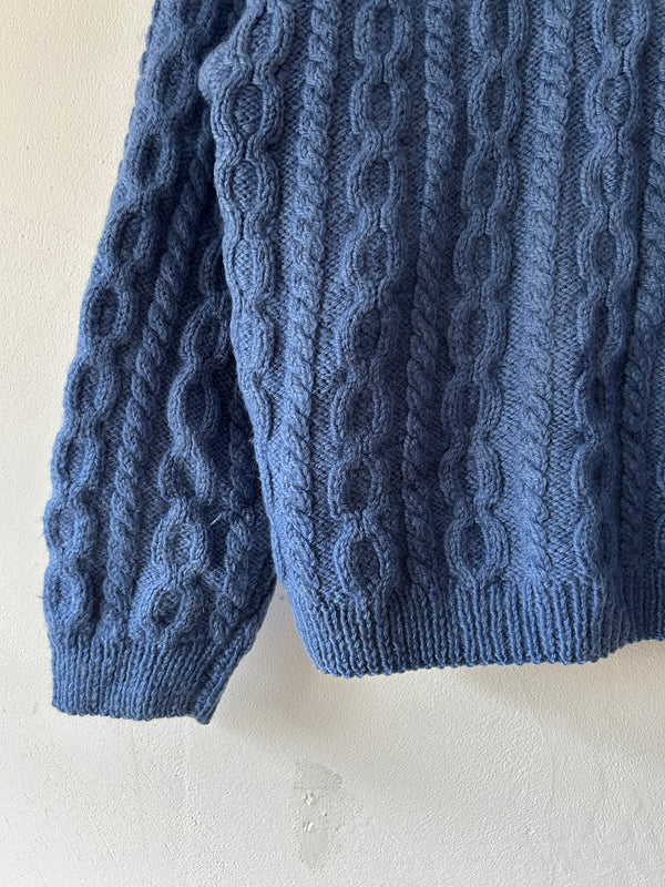 Blue hand cable knit.