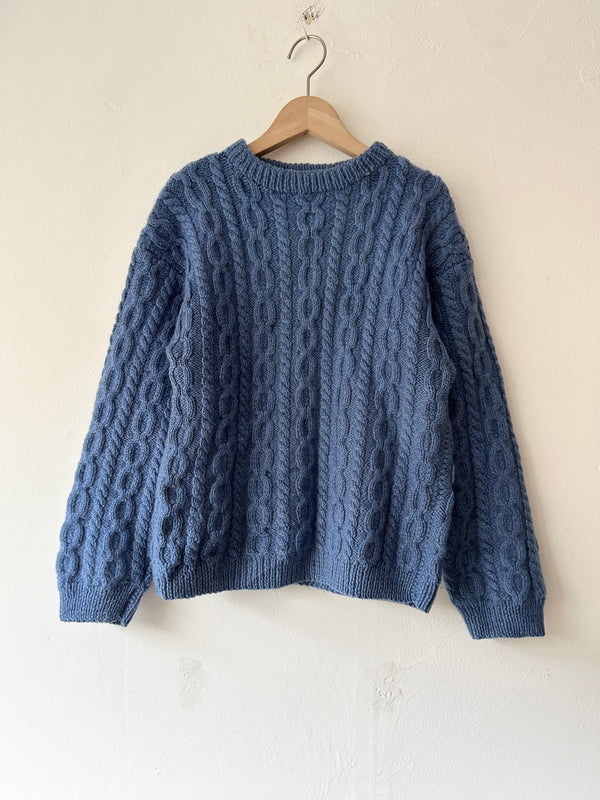 Blue hand cable knit.