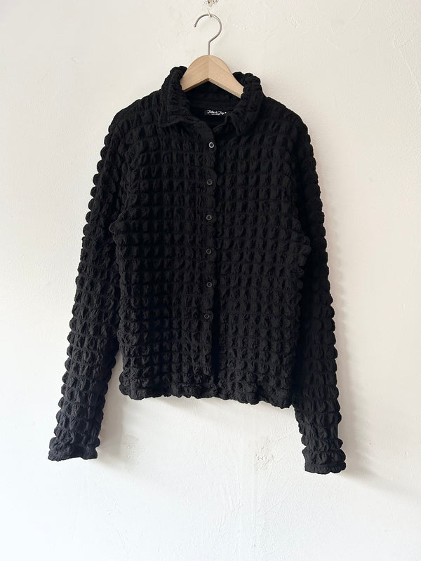 Black pon-pon blouse.