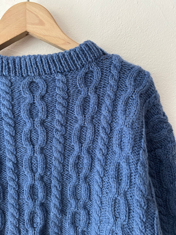 Blue hand cable knit.