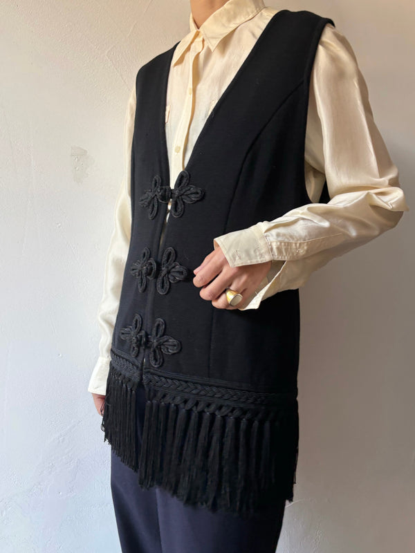 Black fringe knit vest.