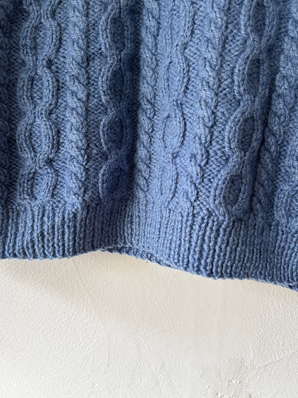 Blue hand cable knit.