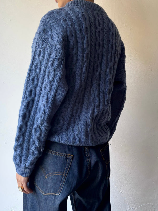 Blue hand cable knit.